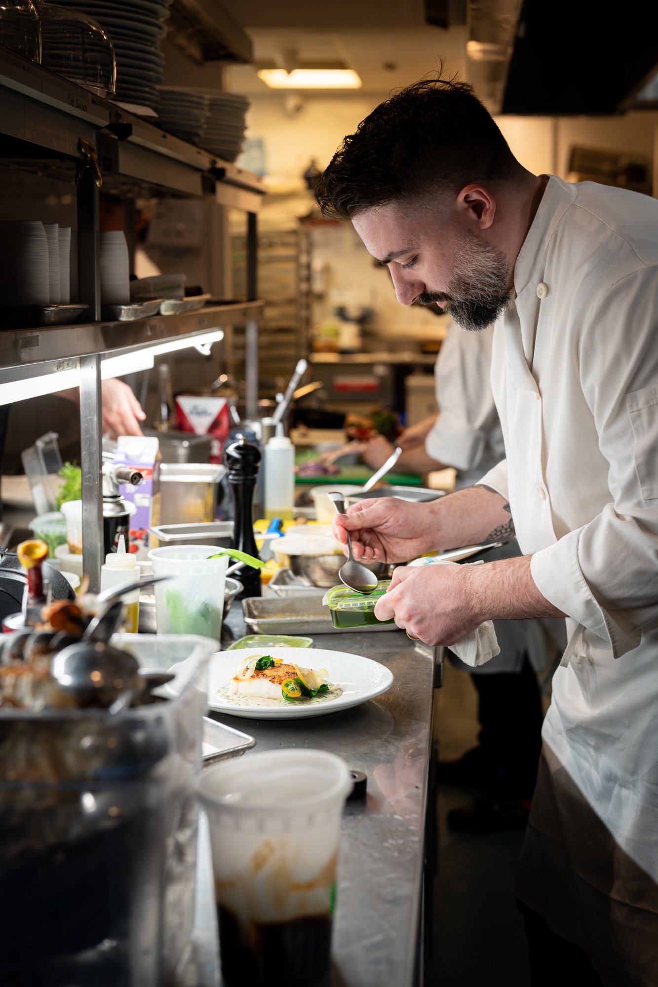 Chef Michael Angeloni plating in the kitchen at Restaurant Lucie