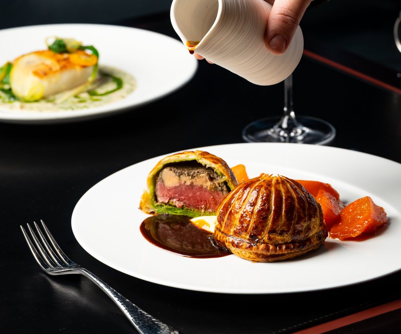 Beef Wellington with sauce at Restaurant Lucie